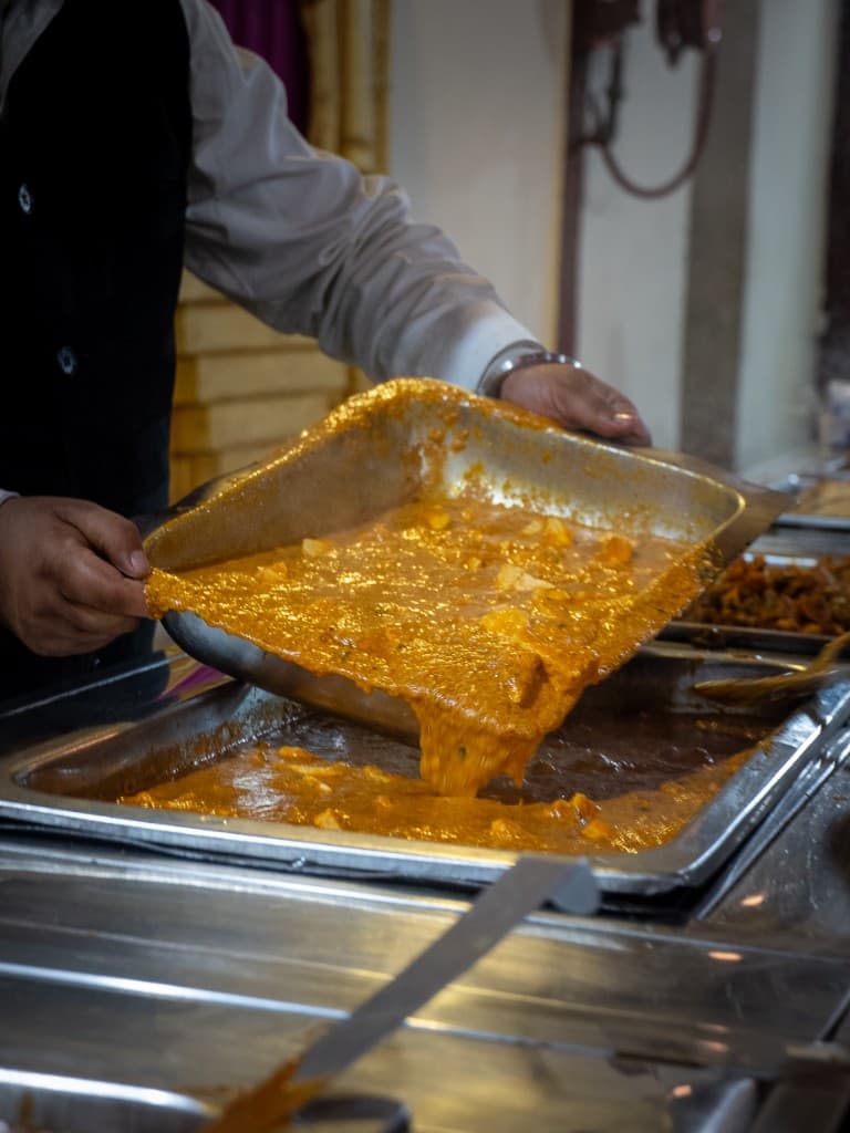 Rich paneer curry being prepared for wedding catering